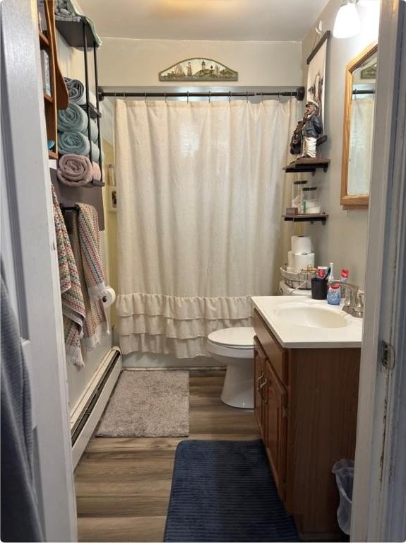 811 Cleveland Ave, Brackenridge, PA 15014 - full bathroom with a baseboard heating unit, wood finished floors, and vanity