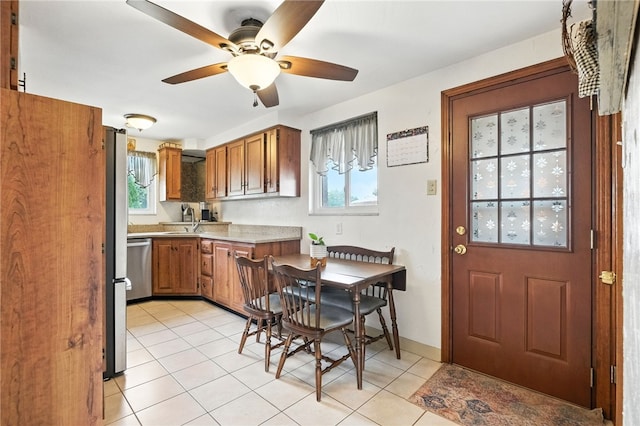 639 Blossom Dr, Baldwin Boro, PA 15236 - kitchen featuring brown cabinetry, light countertops, healthy amount of natural light, and light tile patterned floors