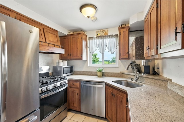 639 Blossom Dr, Baldwin Boro, PA 15236 - kitchen featuring stainless steel appliances, under cabinet range hood, brown cabinetry, light stone counters, and light tile patterned flooring