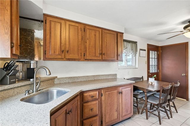 639 Blossom Dr, Baldwin Boro, PA 15236 - kitchen featuring brown cabinetry, ceiling fan, light tile patterned floors, and light stone countertops