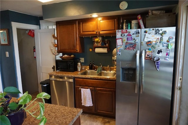 2430 Woodstock Ave, Swissvale, PA 15218 - kitchen with appliances with stainless steel finishes and brown cabinetry