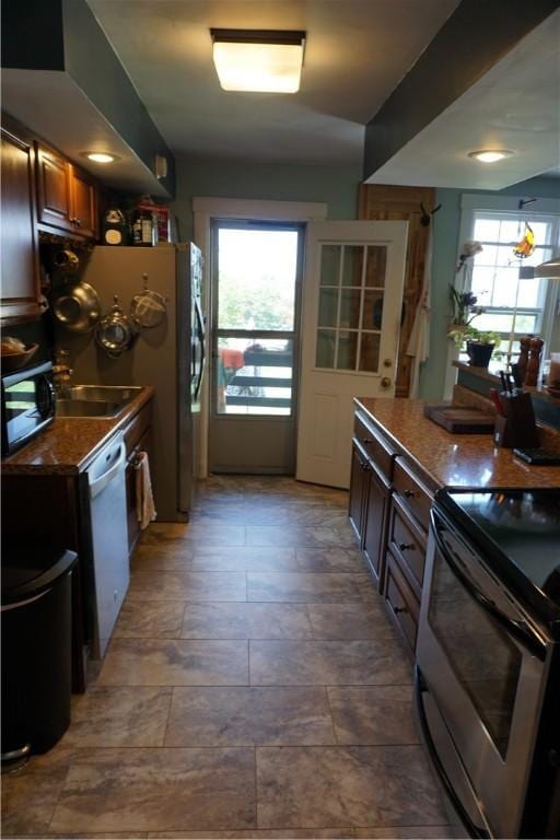 2430 Woodstock Ave, Swissvale, PA 15218 - kitchen with stainless steel range with electric stovetop, white dishwasher, and dark countertops