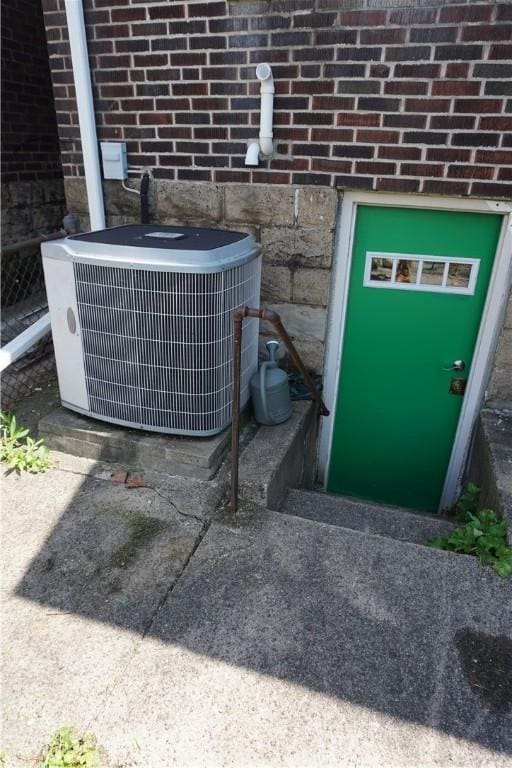 2430 Woodstock Ave, Swissvale, PA 15218 - exterior view of brick siding and a cooling unit