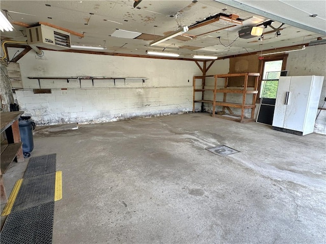 328 Thatcher Rd, Fairfield Twp, PA 15944 - garage with freestanding refrigerator, a garage door opener, and a heating unit