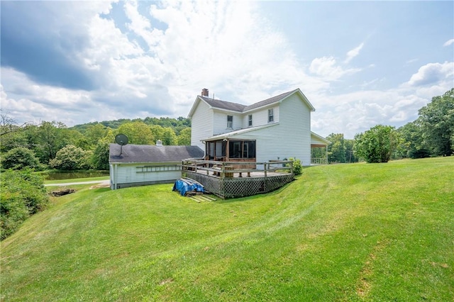 328 Thatcher Rd, Fairfield Twp, PA 15944 - back of house featuring a lawn, a deck, a chimney, and a view of trees