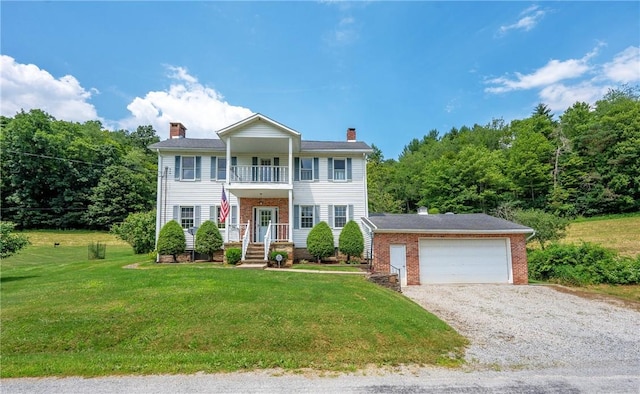 328 Thatcher Rd, Fairfield Twp, PA 15944 - view of front facade with a chimney, a balcony, a front yard, and brick siding