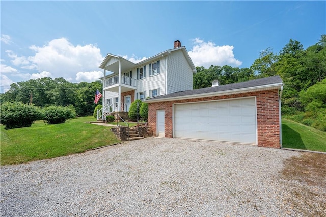 328 Thatcher Rd, Fairfield Twp, PA 15944 - view of front of property with a chimney, brick siding, a garage, and a front lawn