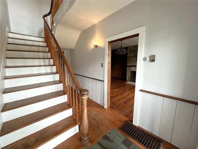 328 Thatcher Rd, Fairfield Twp, PA 15944 - stairs featuring hardwood / wood-style floors, a fireplace, and wainscoting