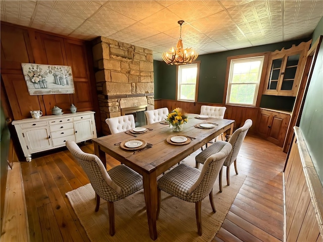 328 Thatcher Rd, Fairfield Twp, PA 15944 - dining space with a chandelier, hardwood / wood-style floors, wood walls, an ornate ceiling, and a wainscoted wall