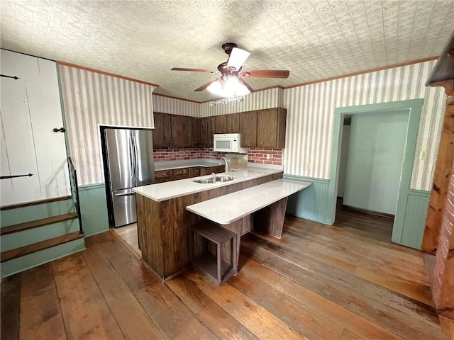 328 Thatcher Rd, Fairfield Twp, PA 15944 - kitchen featuring freestanding refrigerator, light wood-type flooring, light countertops, an ornate ceiling, and white microwave
