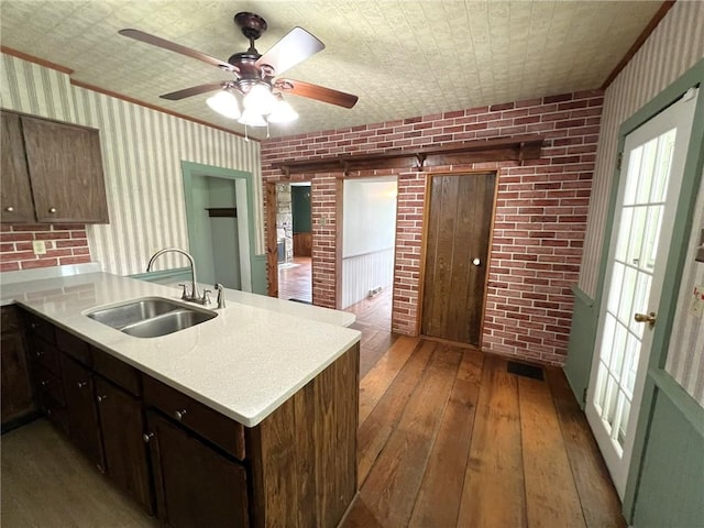 328 Thatcher Rd, Fairfield Twp, PA 15944 - kitchen with wood-type flooring, a peninsula, light countertops, and brick wall