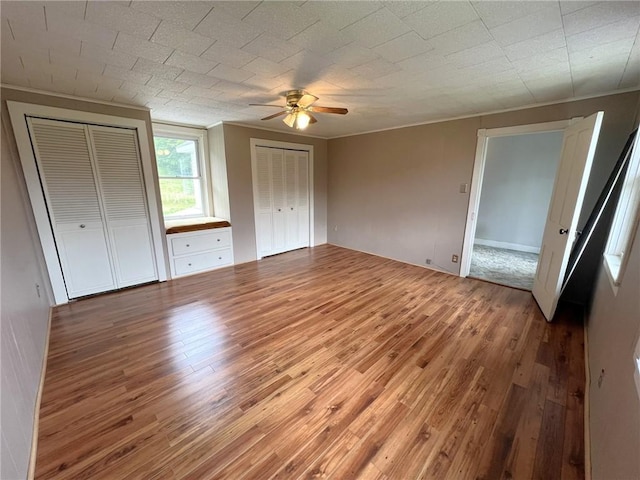 328 Thatcher Rd, Fairfield Twp, PA 15944 - unfurnished bedroom featuring light wood-style flooring, two closets, ceiling fan, and ornamental molding