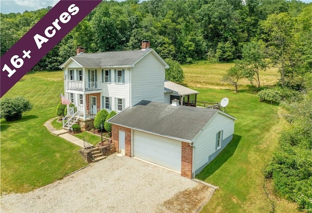 328 Thatcher Rd, Fairfield Twp, PA 15944 - view of front of home with a balcony, a chimney, brick siding, a garage, and a front lawn