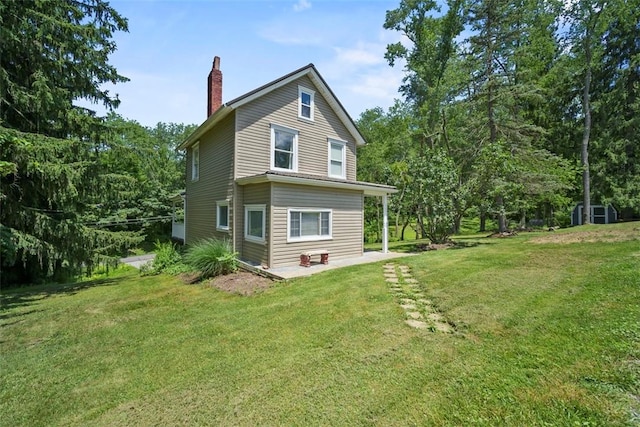 102 Clarks Ln, Adams Twp, PA 16046 - back of house with a chimney, a yard, and a patio area