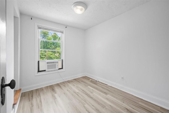 102 Clarks Ln, Adams Twp, PA 16046 - spare room featuring light wood-type flooring, a textured ceiling, and cooling unit