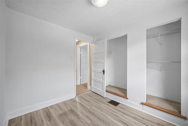 102 Clarks Ln, Adams Twp, PA 16046 - unfurnished bedroom featuring wood finished floors, a closet, and a textured ceiling