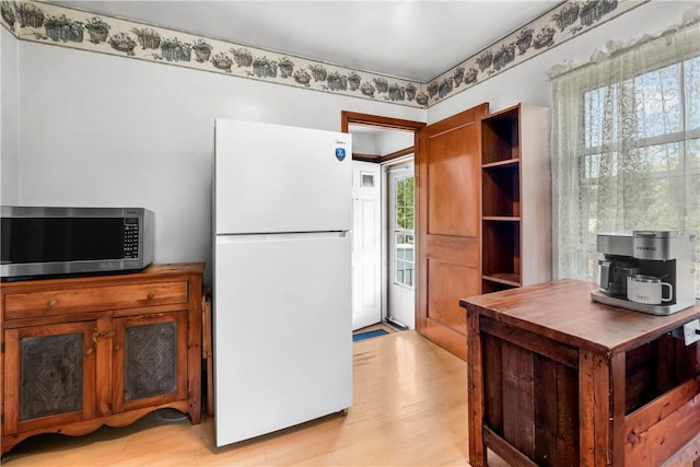 8 Harmar Dr, Cheswick, PA 15024 - kitchen with freestanding refrigerator, stainless steel microwave, light wood-type flooring, brown cabinets, and open shelves