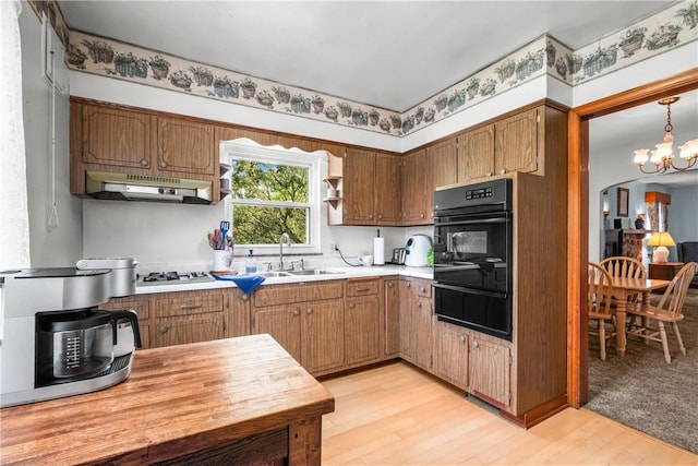 8 Harmar Dr, Cheswick, PA 15024 - kitchen with a warming drawer, black oven, under cabinet range hood, gas cooktop, and light wood finished floors