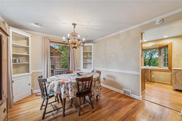 192 Glenfield Dr, Penn Hills, PA 15235 - dining space with light wood-type flooring, plenty of natural light, a chandelier, and crown molding