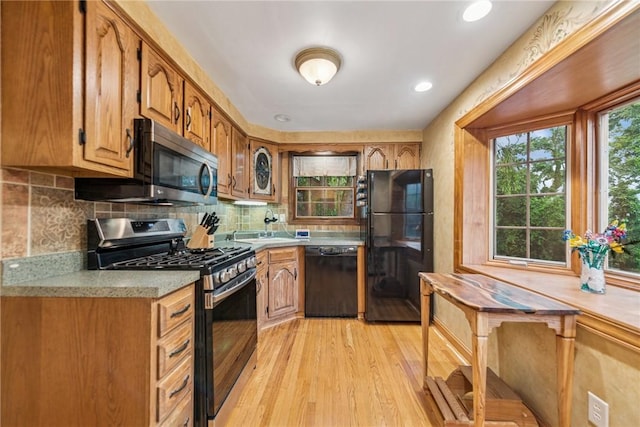 192 Glenfield Dr, Penn Hills, PA 15235 - kitchen featuring black appliances, light countertops, light wood-style flooring, backsplash, and recessed lighting