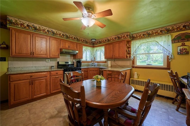 2583 State Route 210, Cowanshanock Twp, PA 16249 - kitchen with under cabinet range hood, radiator, appliances with stainless steel finishes, and brown cabinets