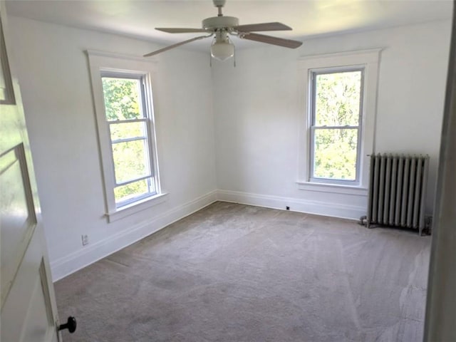 413 N 3rd St, Jeannette, PA 15644 - carpeted empty room featuring radiator heating unit, plenty of natural light, and a ceiling fan