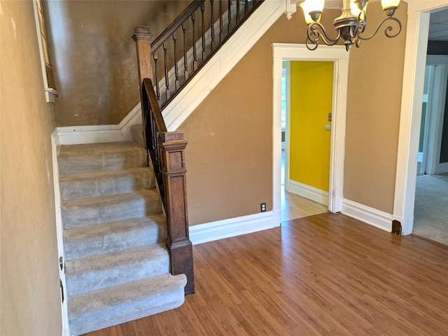 413 N 3rd St, Jeannette, PA 15644 - stairs with a chandelier and wood finished floors
