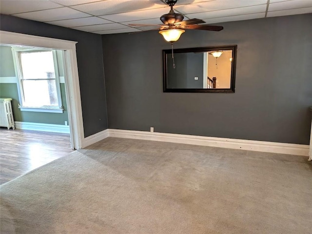 413 N 3rd St, Jeannette, PA 15644 - carpeted empty room with radiator heating unit, a paneled ceiling, and ceiling fan