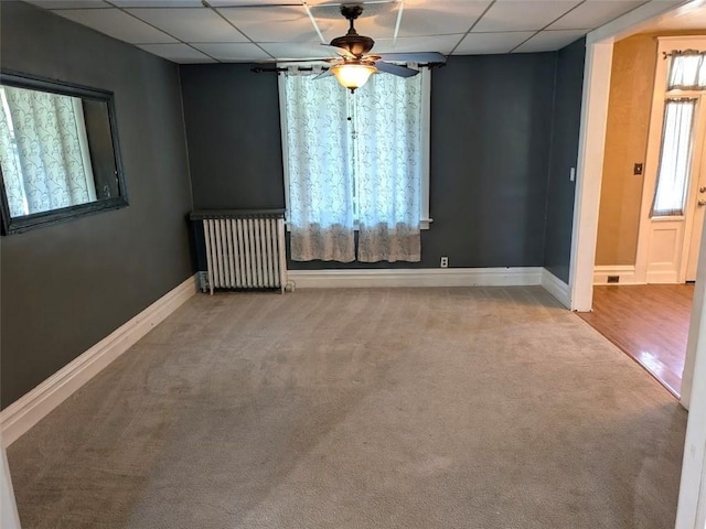 413 N 3rd St, Jeannette, PA 15644 - spare room with radiator, a paneled ceiling, carpet floors, and a ceiling fan