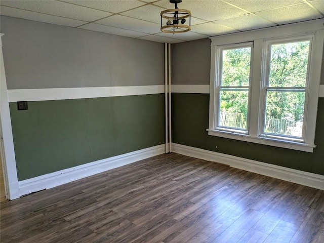 413 N 3rd St, Jeannette, PA 15644 - empty room featuring dark wood-style floors, healthy amount of natural light, and a drop ceiling