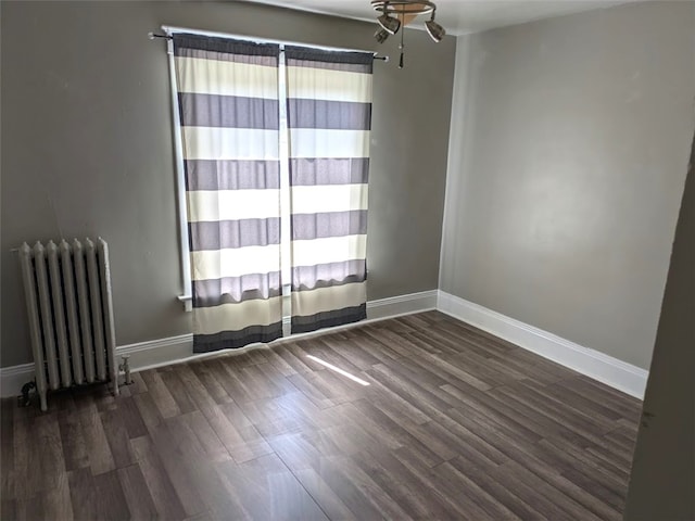 413 N 3rd St, Jeannette, PA 15644 - empty room with radiator and wood finished floors