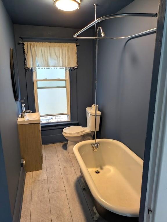413 N 3rd St, Jeannette, PA 15644 - full bathroom featuring a freestanding bath, a shower, vanity, and wood finished floors