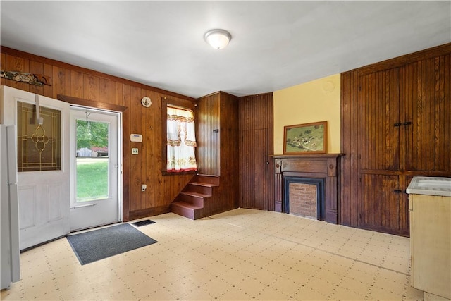 481 Dille Run Rd, Morris Twp, PA 15329 - entrance foyer with a fireplace, wooden walls, tile patterned floors, and stairs
