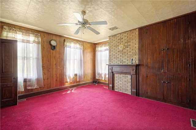 481 Dille Run Rd, Morris Twp, PA 15329 - unfurnished living room with carpet, ceiling fan, wood walls, and a fireplace