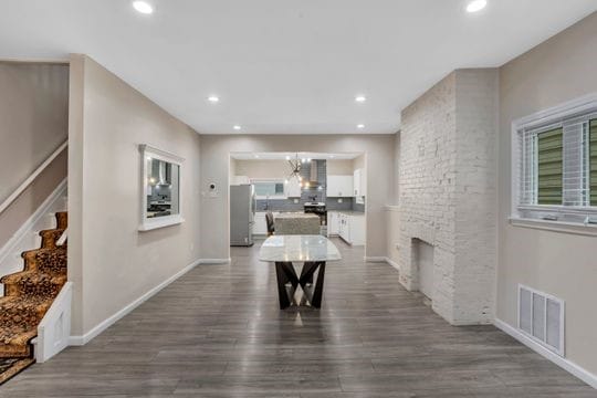 1850 Middle St, Sharpsburg, PA 15215 - dining space featuring dark wood-style floors, stairway, recessed lighting, a fireplace, and a chandelier
