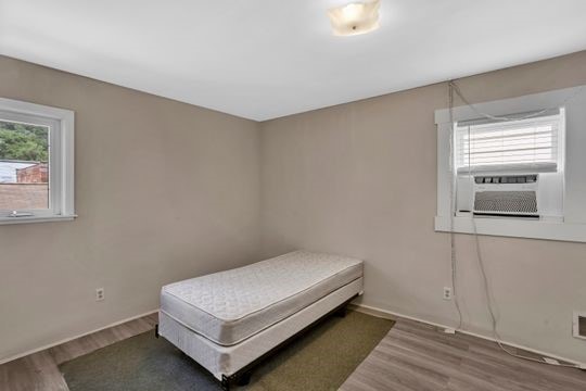 1850 Middle St, Sharpsburg, PA 15215 - bedroom featuring wood finished floors and cooling unit