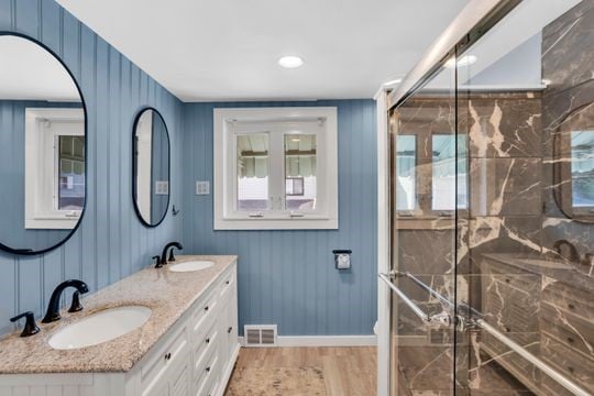 1850 Middle St, Sharpsburg, PA 15215 - full bathroom with double vanity, a marble finish shower, and wood finished floors