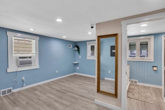1850 Middle St, Sharpsburg, PA 15215 - empty room with wood finished floors, cooling unit, and recessed lighting