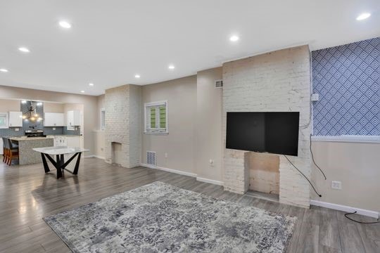 1850 Middle St, Sharpsburg, PA 15215 - living room with a fireplace, wood finished floors, and recessed lighting