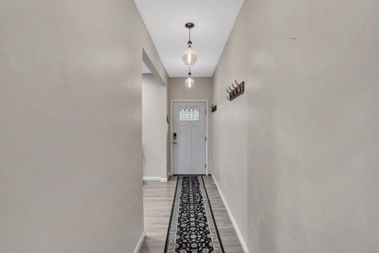 1850 Middle St, Sharpsburg, PA 15215 - doorway to outside with baseboards and light wood-style flooring