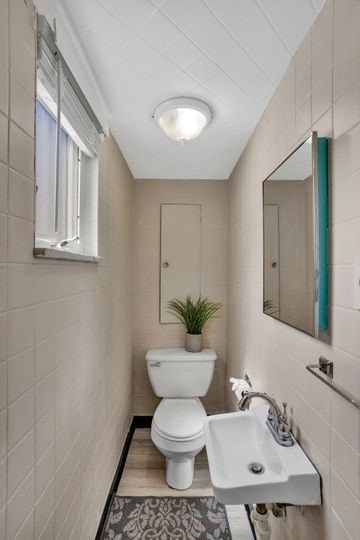 1850 Middle St, Sharpsburg, PA 15215 - bathroom featuring tile walls and wood finished floors
