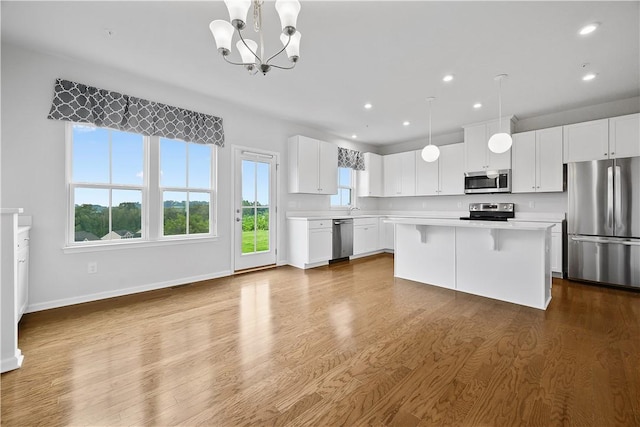 1208 Clear Springs Dr, Cecil, PA 15317 - kitchen featuring stainless steel appliances, light countertops, a chandelier, a center island, and dark wood-type flooring