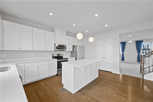 1208 Clear Springs Dr, Cecil, PA 15317 - kitchen featuring appliances with stainless steel finishes, a center island, dark wood-style flooring, white cabinets, and recessed lighting