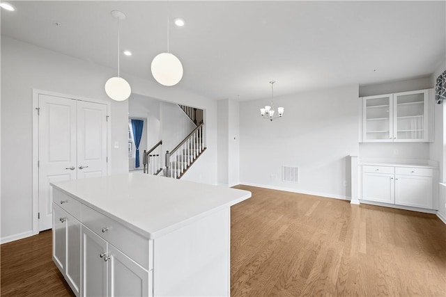 1208 Clear Springs Dr, Cecil, PA 15317 - kitchen featuring light wood finished floors, white cabinetry, a chandelier, light countertops, and a center island
