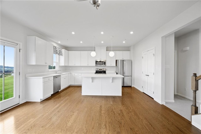 1208 Clear Springs Dr, Cecil, PA 15317 - kitchen with stainless steel appliances, light countertops, white cabinets, recessed lighting, and a kitchen island