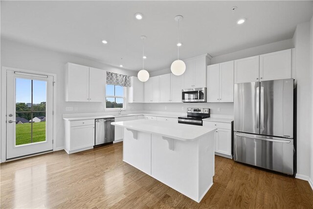 1208 Clear Springs Dr, Cecil, PA 15317 - kitchen with stainless steel appliances, light countertops, white cabinetry, a kitchen island, and dark wood-style floors