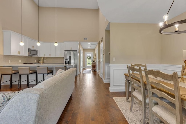 113 Dano Dr Unit 37, Ohioville, PA 15009 - living area with a high ceiling, a wainscoted wall, and dark wood-style flooring