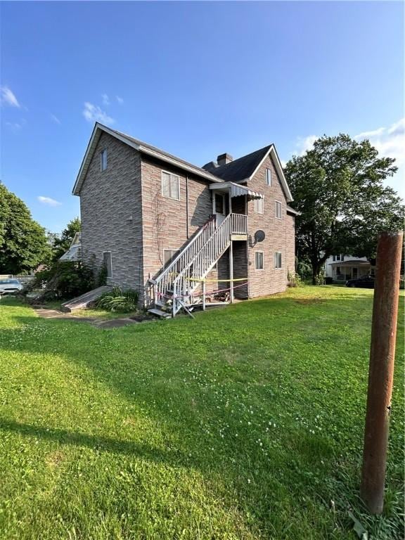 431 Washington Ave, Leechburg Boro, PA 15656 - rear view of house with stairs, a lawn, and stone siding
