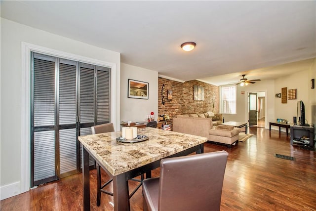 118 S 17th St, South Side, PA 15203 - dining space with brick wall, a ceiling fan, and dark wood-type flooring