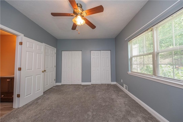 108 Arthur Ct, Richland, PA 15044 - unfurnished bedroom featuring multiple closets, carpet, a ceiling fan, and a textured ceiling